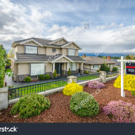 stock-photo-house-for-sale-real-estate-sign-in-front-of-a-house-137795501